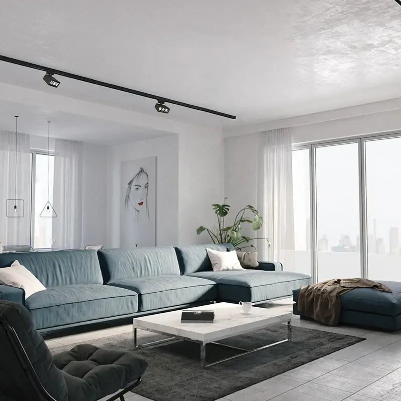 Blue sectional sofa with plush fabric and white throw pillows under decorbites led track light for home use