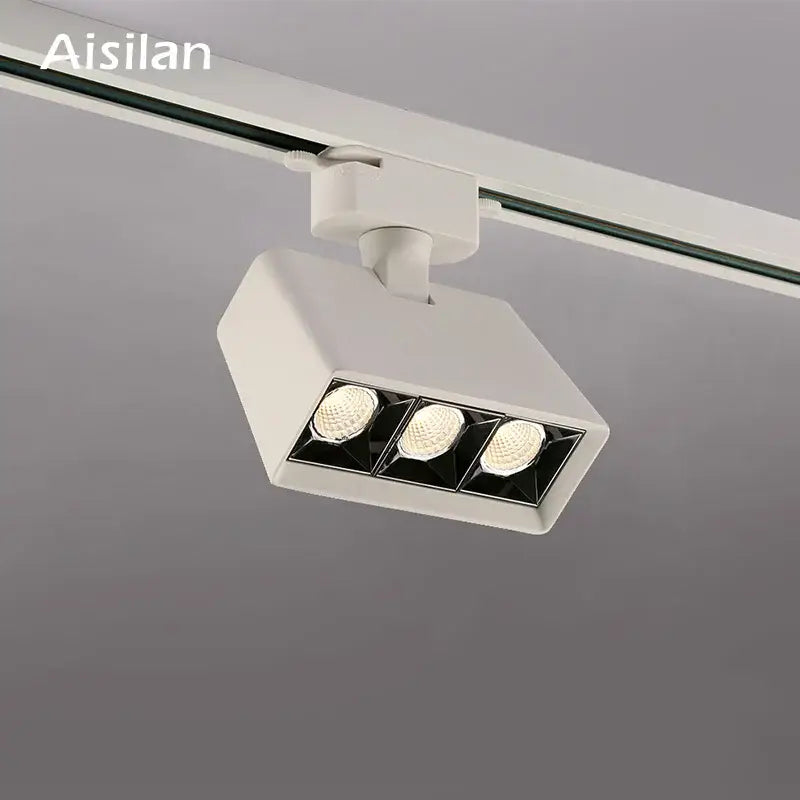 White aisilan decorbites led track light fixture with three led bulbs in rectangular housing for commercial use