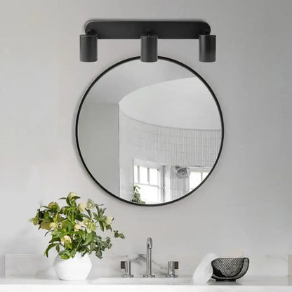 Black round mirror with minimalist frame mounted above sink complementing decorbites led track spot light for bedroom corridor