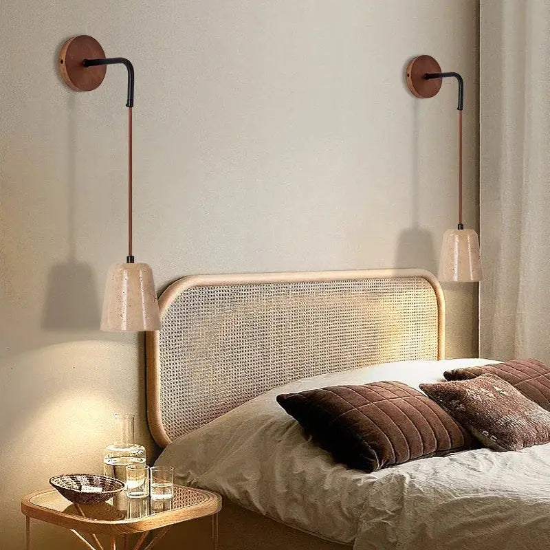 Pair of decorbites led travertine stone wall lamps with copper bases black arms and speckled off-white ceramic shades