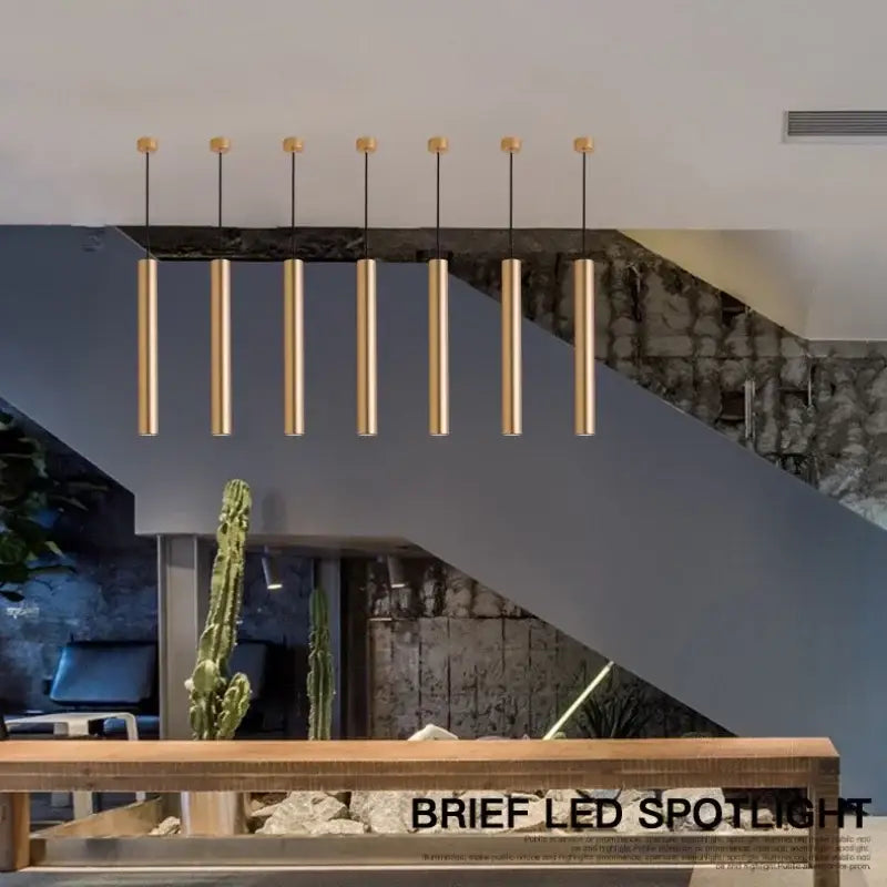 Six sleek gold-finished decorbites led tube pendant lights in a modern arrangement for dining room and kitchen use