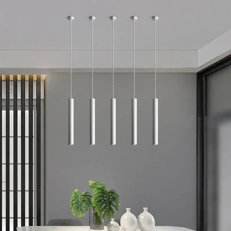 Five sleek white cylindrical pendant lights from decorbites led tube pendant for dining room and kitchen lighting