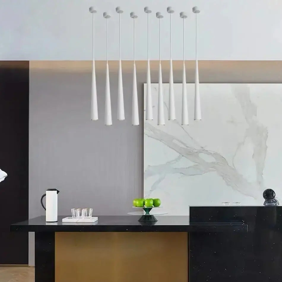 A modern white decorbites led tube pendant light fixture with sleek tapered cones for kitchen dining room bar lighting
