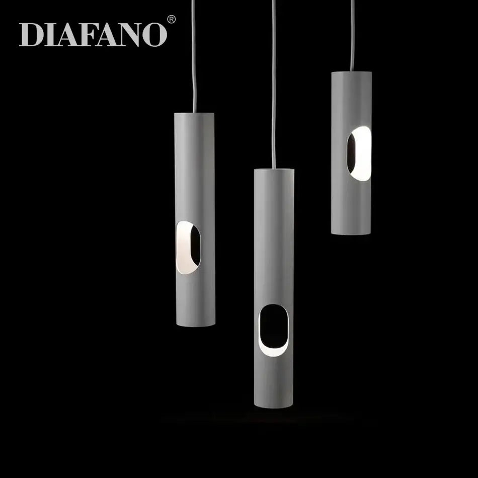 Three sleek matte gray cylindrical decorbites led tube surface mount pendant lights with oval cutouts emit soft glow