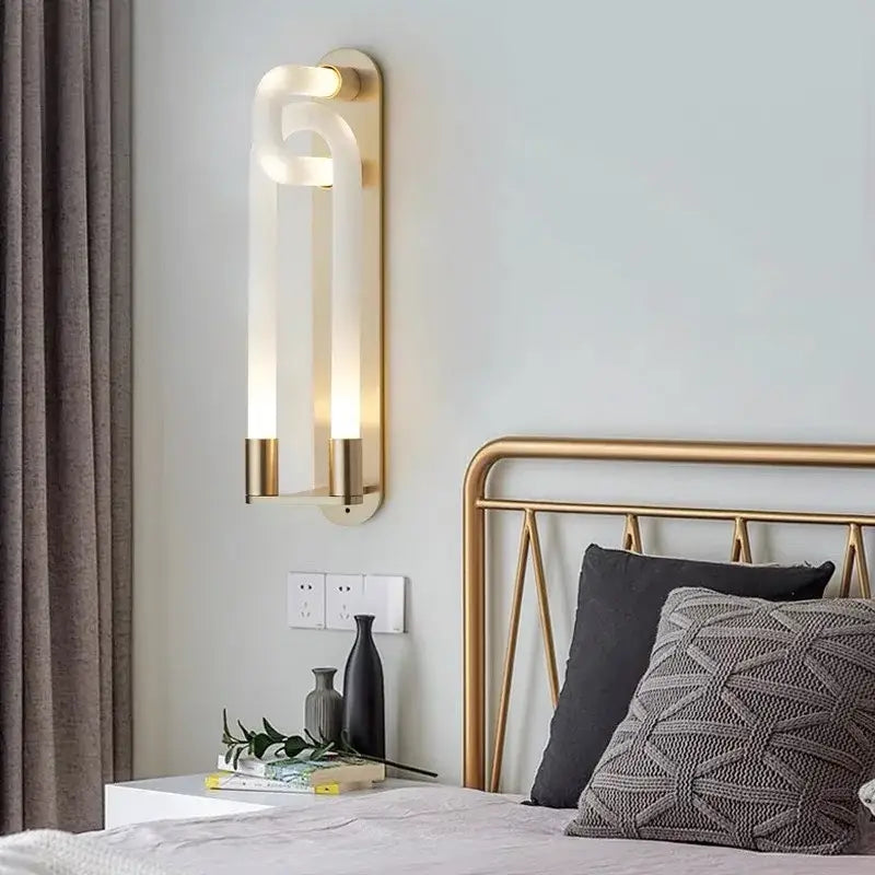 Gold-toned DecorBites led tube wall sconce with sleek curved acrylic diffuser and two vertical LED tube lights