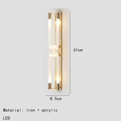 Modern gold-toned decorbites led tube wall sconce with two acrylic light tubes framed by black iron metal