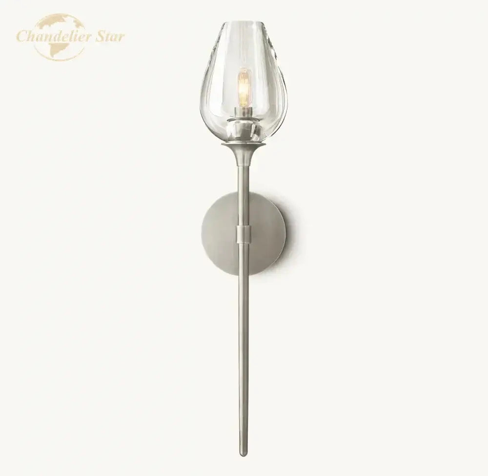 A sleek decorbites led tulip wall sconce with a clear glass shade and brushed nickel stem for indoor lighting