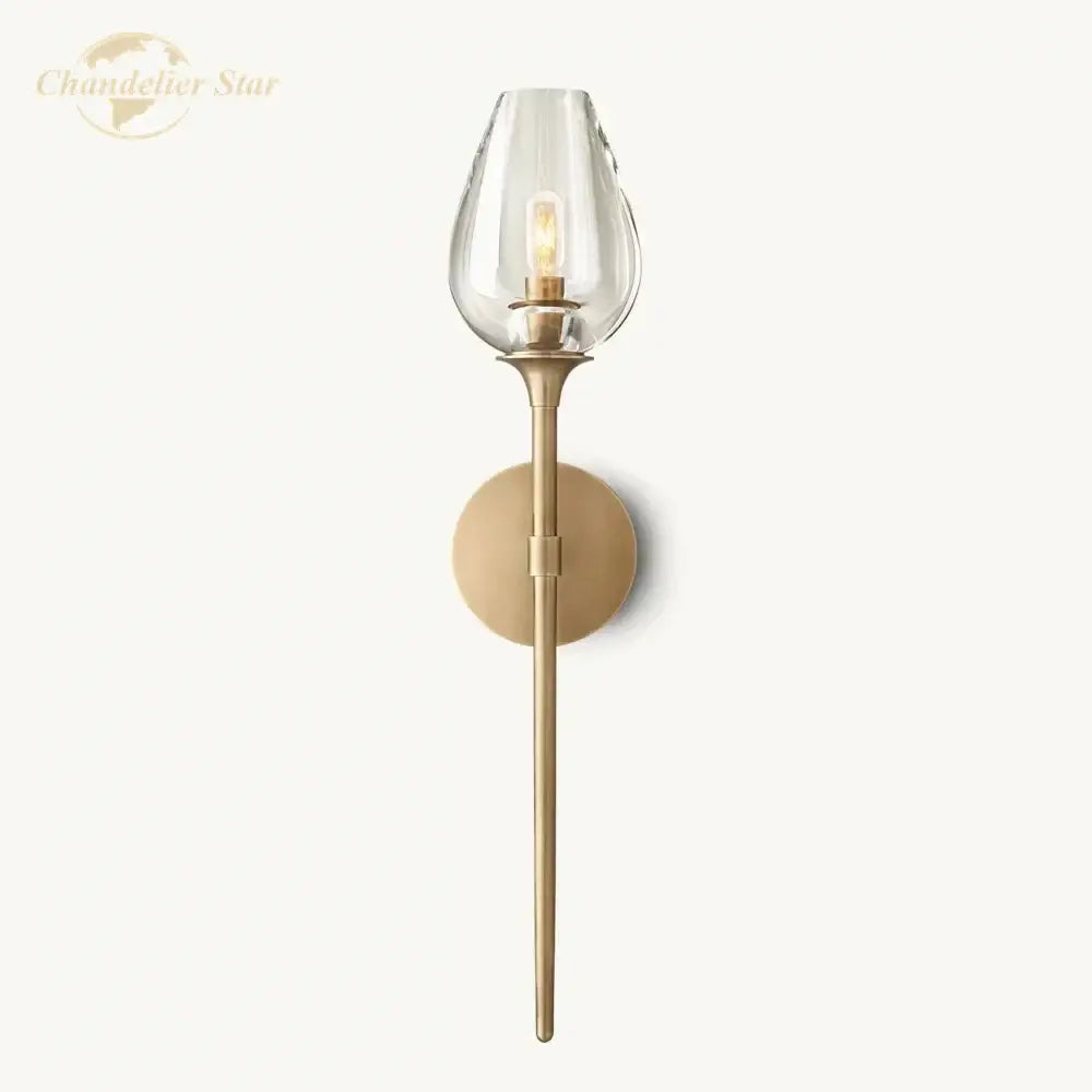 A sleek brass decorbites led tulip wall sconce with clear glass teardrop shade and exposed filament bulb for indoor use