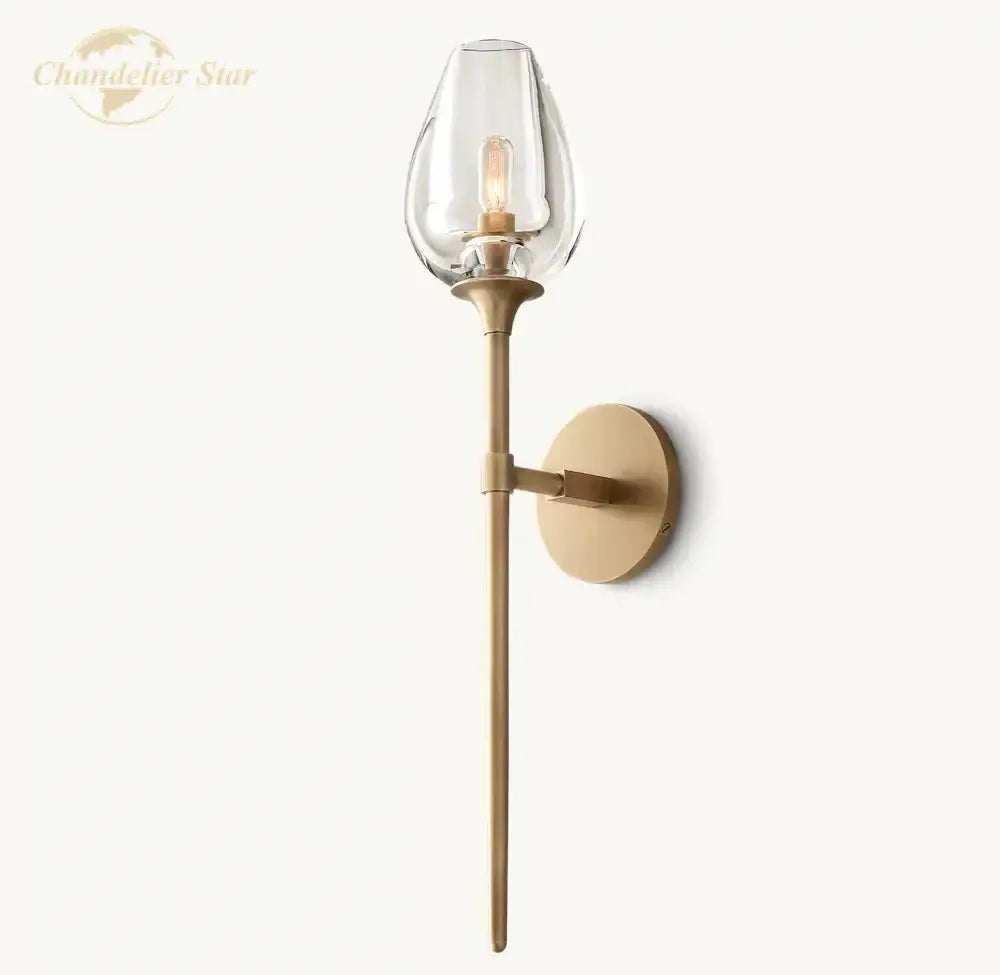 A sleek brass decorbites led tulip wall sconce with clear glass teardrop shade and exposed filament bulb for indoor use
