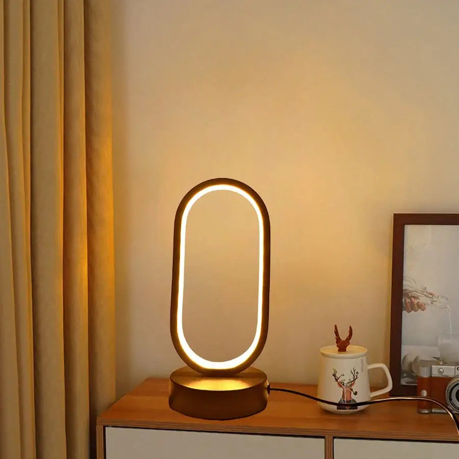 Gold-toned oval led table lamp with sleek modern design and warm ambient lighting for lamp bedroom bedside use