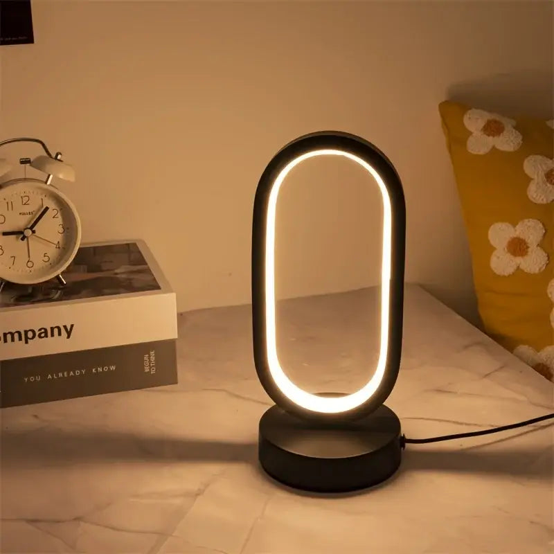 DecorBites™ modern black oval-shaped led lamp bedroom bedside with glowing circular light ring for decorative use