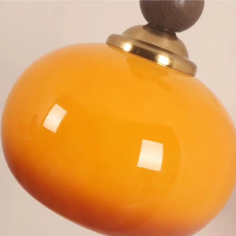 Vibrant orange ceramic pendant lamp with brass accent and dark wood top from decorbites led wall collection