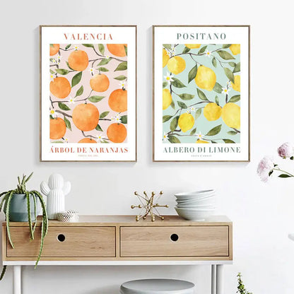 Two framed vintage plant wall art prints featuring lemon flower and valencia citrus tree watercolor illustrations
