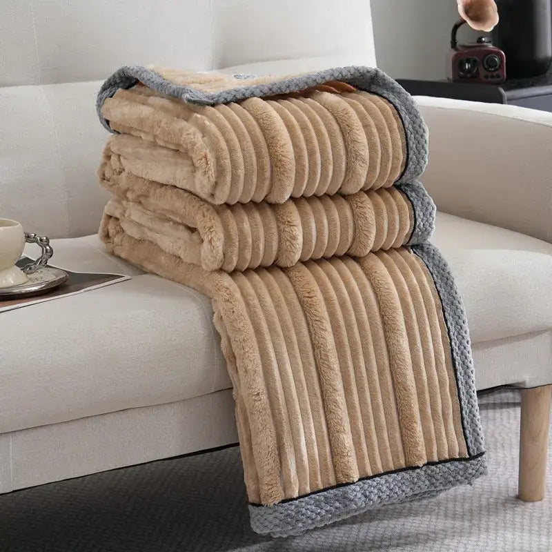 A plush beige and gray ribbed decorbites light luxury sofa blanket with a soft textured surface for bedroom or sofa use