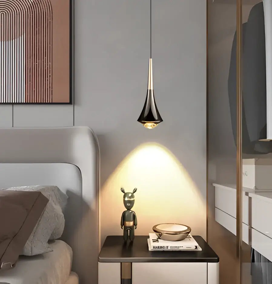 Black and gold decorbites chandelier with sleek tapered pendant light luxury meteor design above nightstand