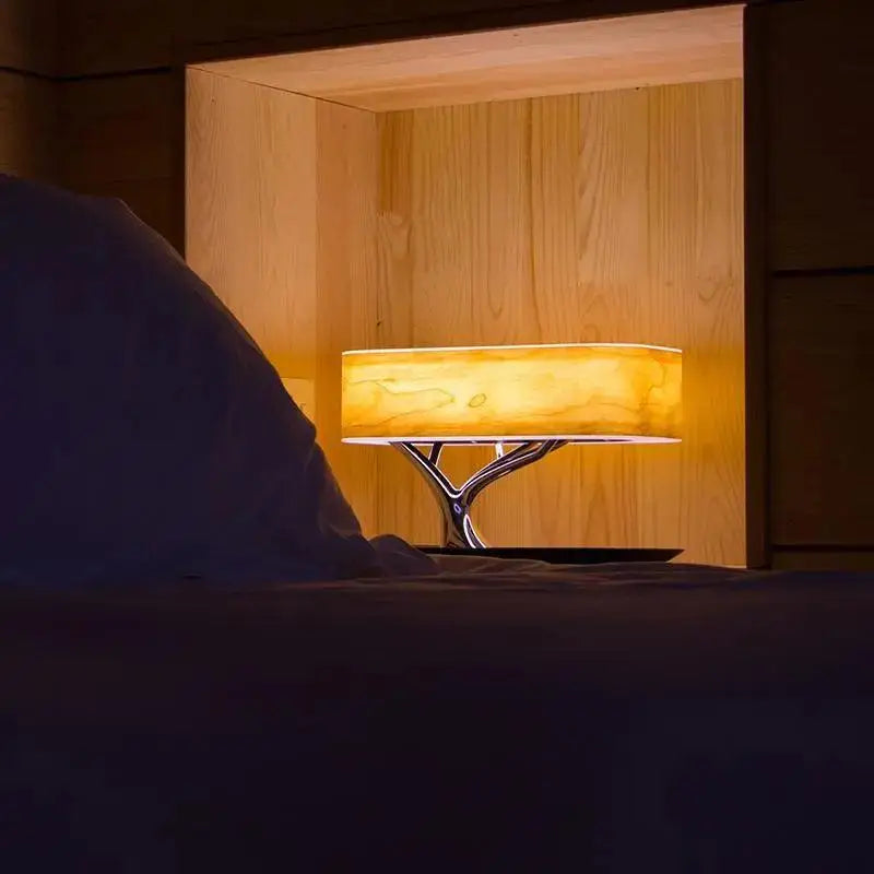 Decorbites™ light of life table lamp with warm amber light, chrome tree-like base, and translucent wooden shade