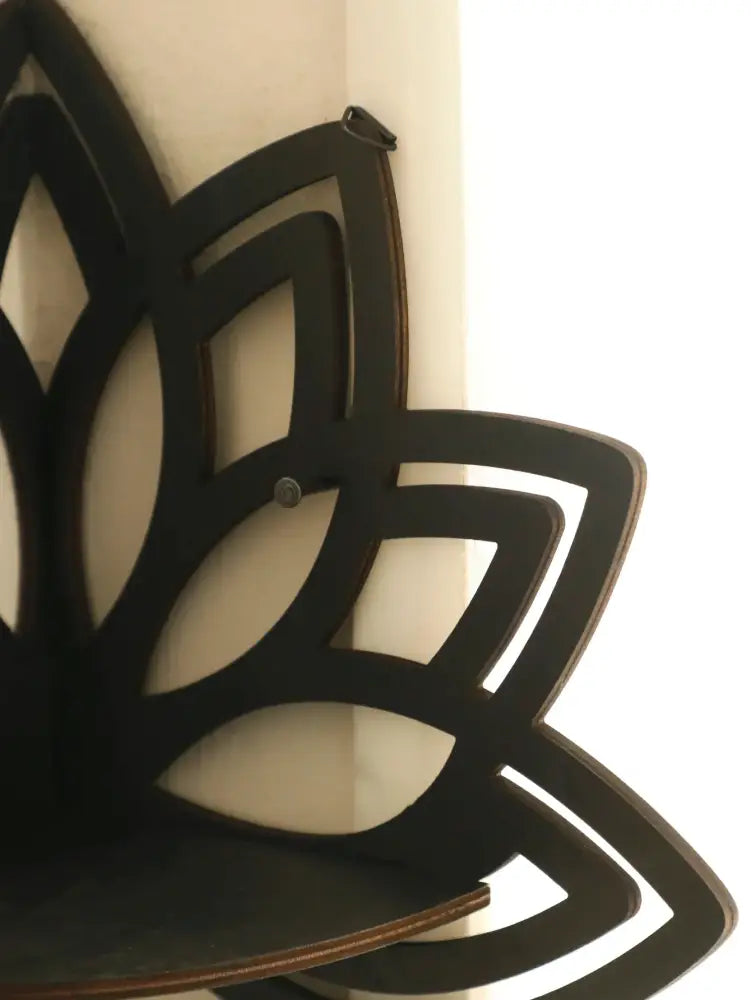 Black wooden lotus floating wall shelf with layered petal design and flat bottom surface by DecorBites™
