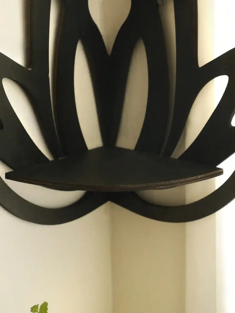 Black metal lotus floating wall shelf with flat curved display surface for versatile home decor by DecorBites™