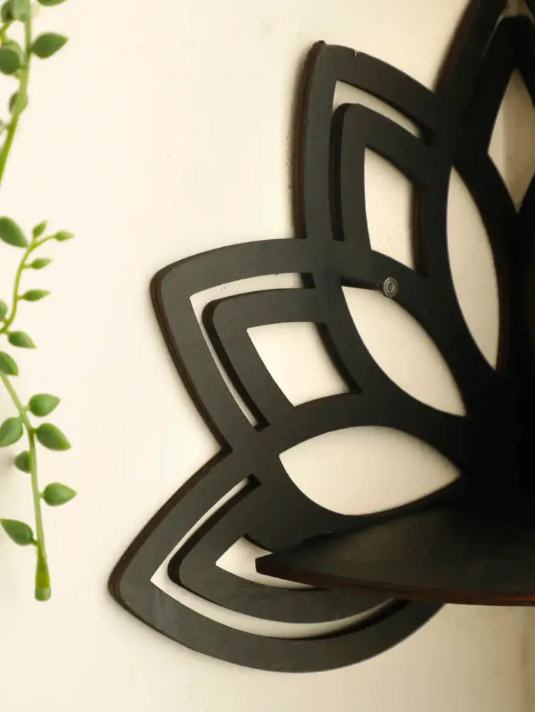 Black metal lotus floating wall shelf with layered petal design perfect for multi-style home decor by decorbites