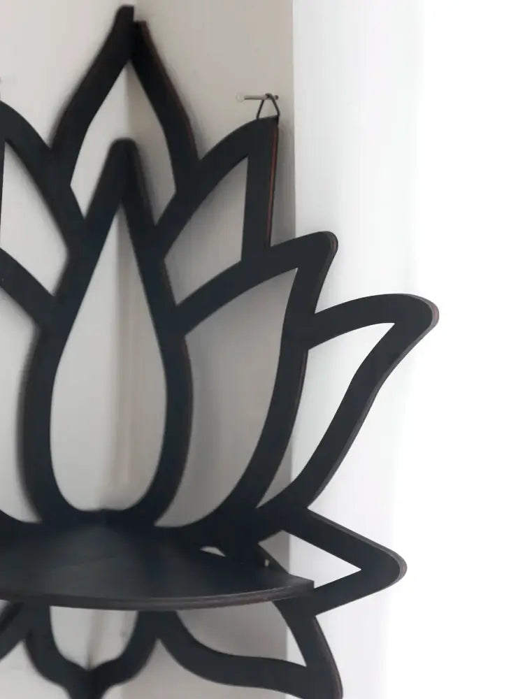 Black lotus floating wall shelf with sleek minimalist design and smooth matte finish for modern home decor