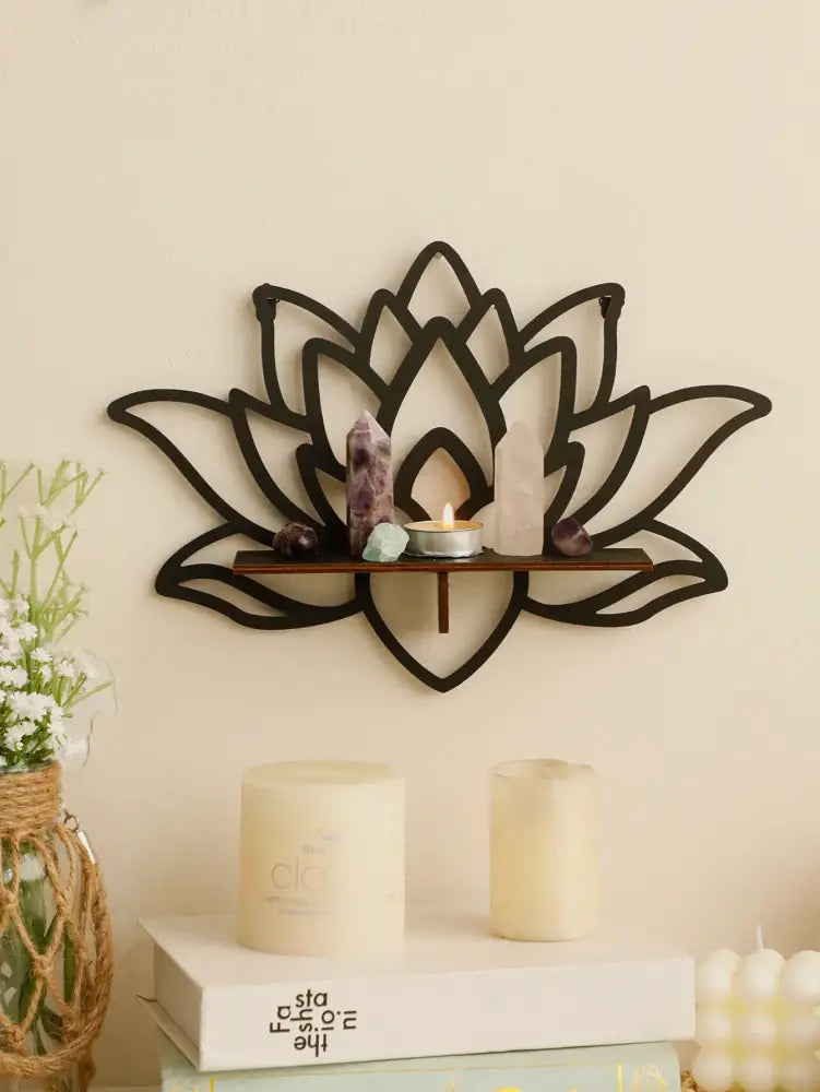 Black metal lotus floating wall shelf with wooden slat holding crystals and a lit candle for multi-style decor