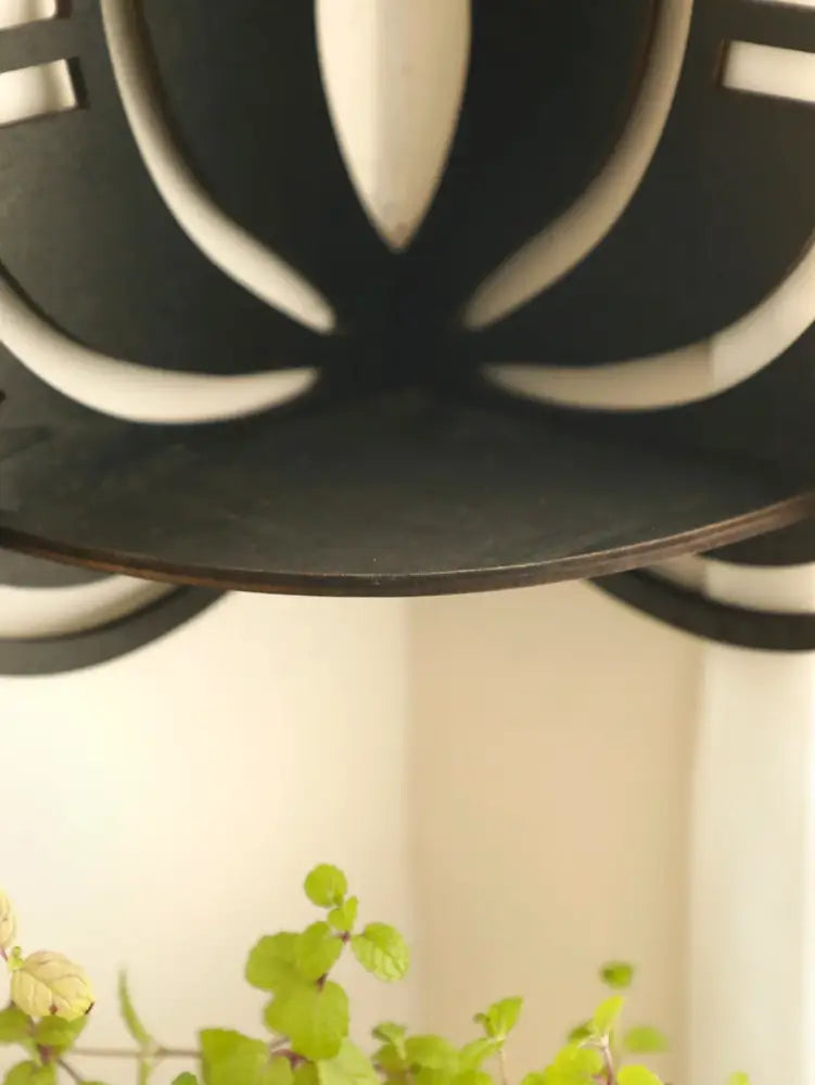 Black metal lotus floating wall shelf with leaf design from decorbites multi-style home decor collection