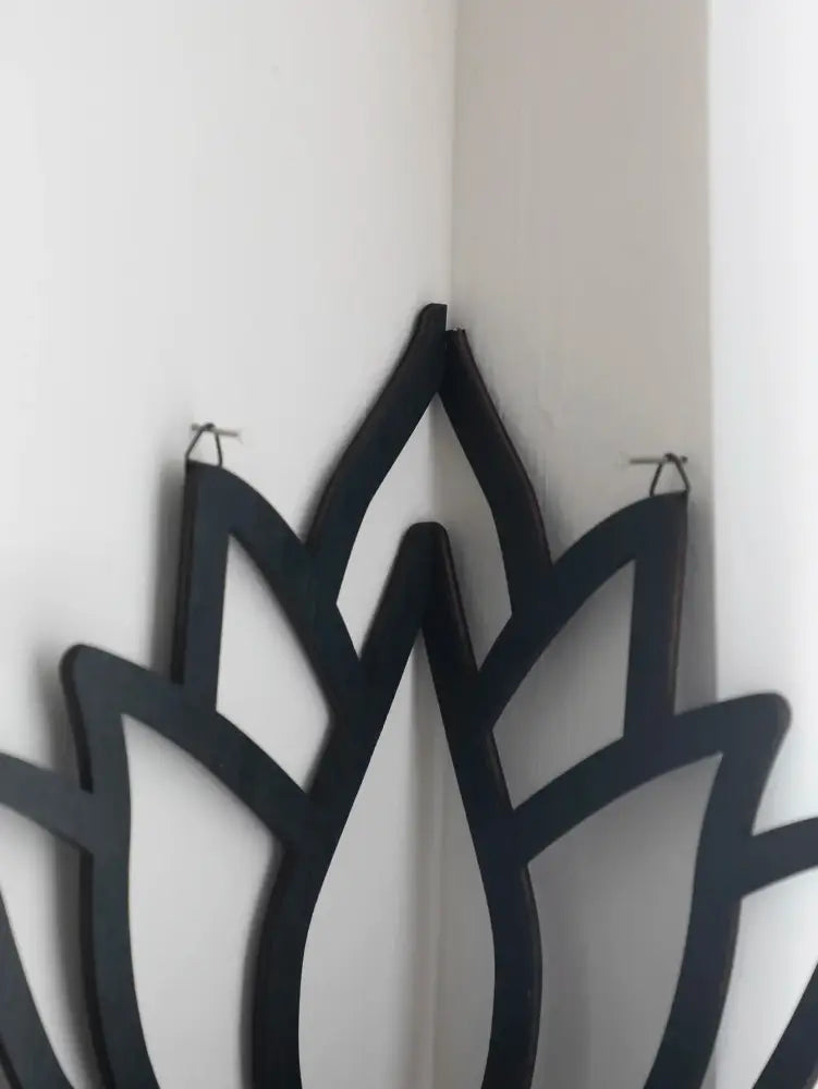 DecorBites™ black metal lotus floating wall shelf with sleek cut-out petals and hanging hooks for multi-style decor