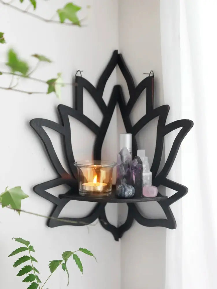 Black metal lotus floating wall shelf with central glass candle holder and crystal decor for multi-style home decor