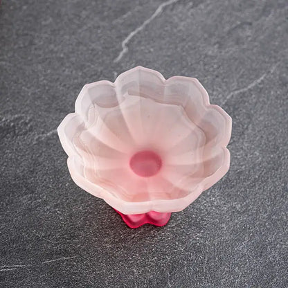 A translucent pink silicone lotus flower mold with petal details for decorbites lotus flower glass tea cups
