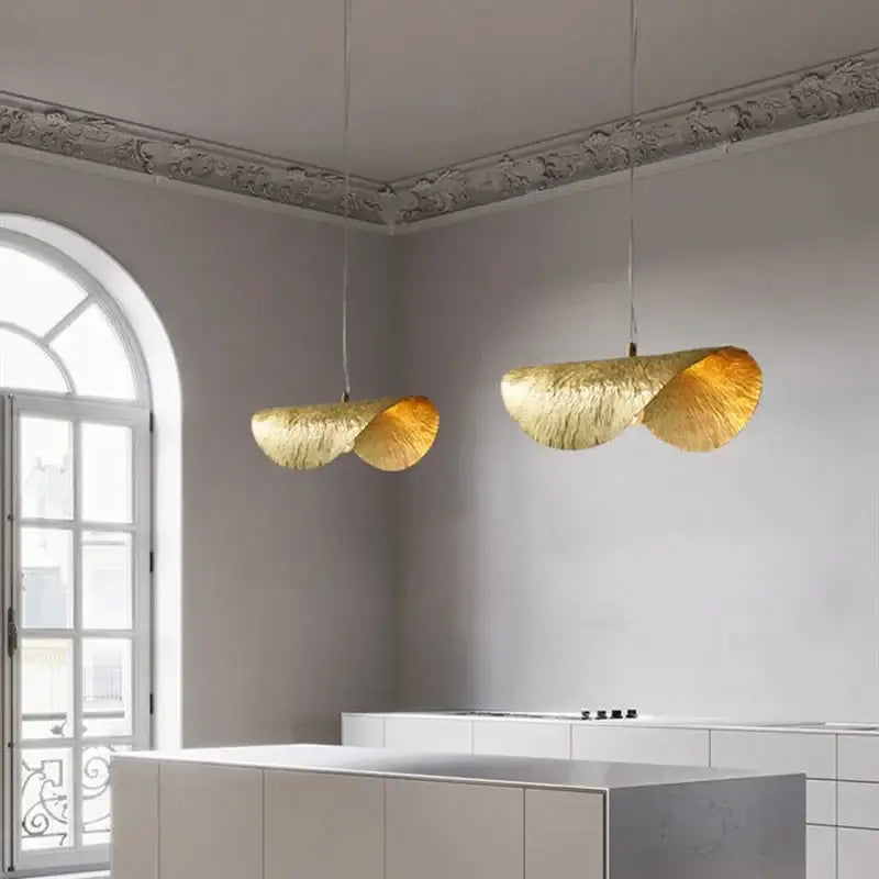 Two elegant golden pendant lights with textured lotus flower design by DecorBites for dining room and hotel decor