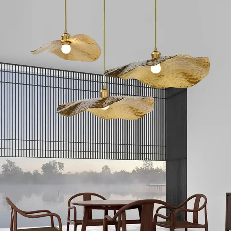 Three golden hammered metal pendant lights with lotus flower shapes by DecorBites for dining room and hotel decor