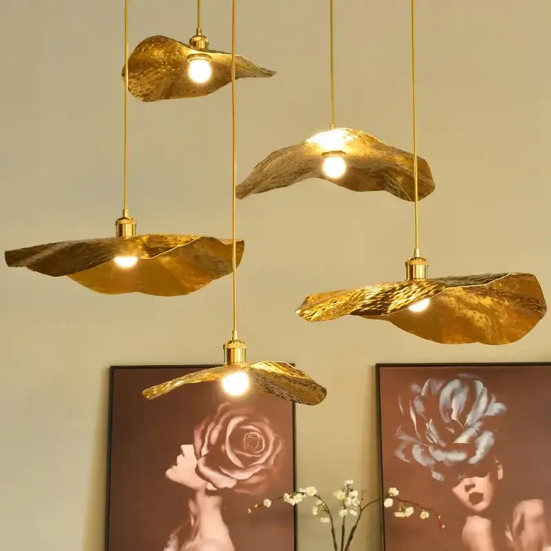 Decorbites lotus flower pendant light with gold leaf-shaped hammered texture and slender brass cords for dining room decor