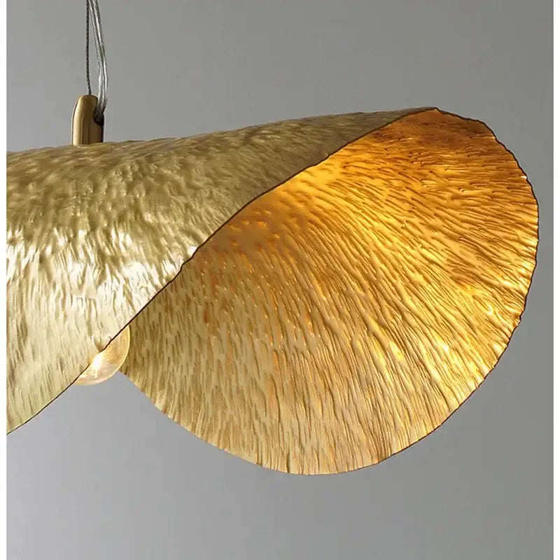 Golden hammered metal pendant light with lotus flower design from decorbites for dining room and hotel decor