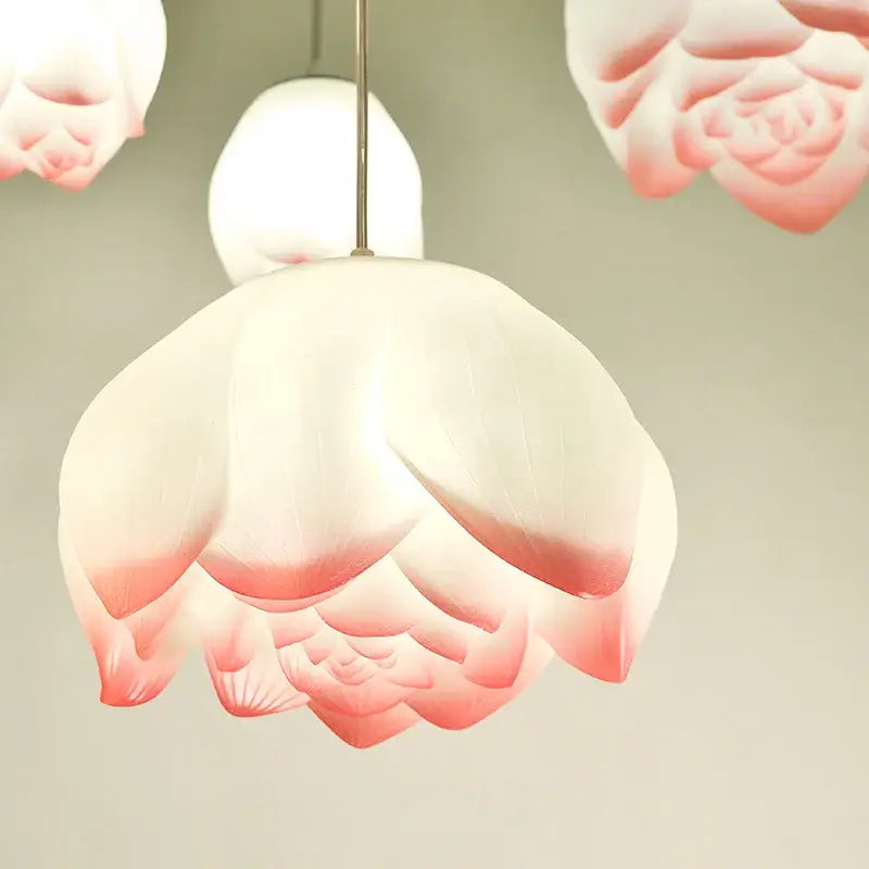 Decorbites lotus glass pendant lamp features a delicate white and pink gradient lotus flower shape in translucent glass