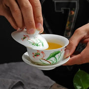 White porcelain gaiwan tea set with hand-drawn red and green lotus flowers by DecorBites lotus for puer tea brewing