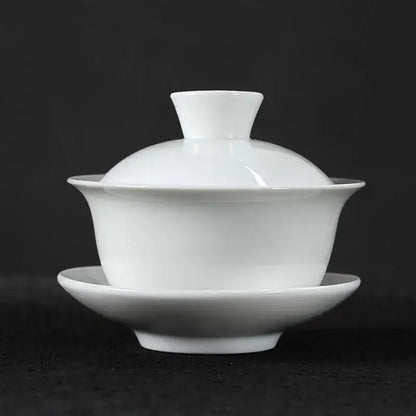 White porcelain gaiwan tea set with matching lid and saucer featuring smooth glaze in decorbites lotus design