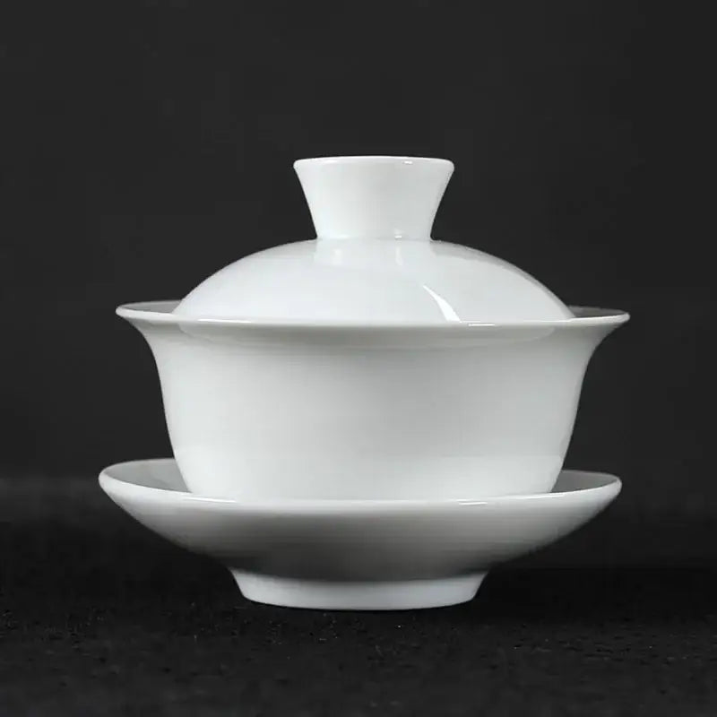 White porcelain gaiwan tea set with matching lid and saucer featuring smooth glaze in decorbites lotus design