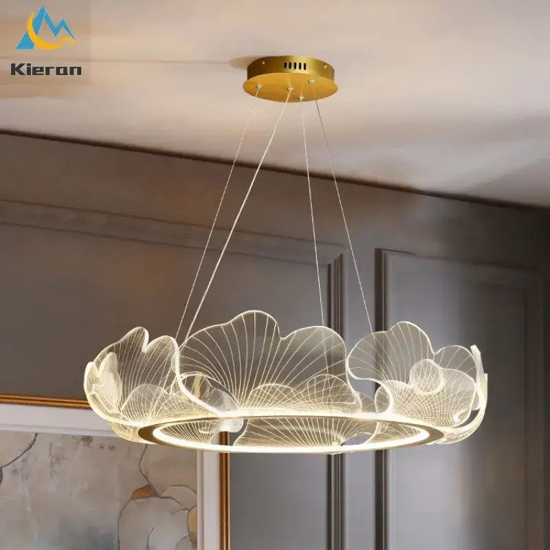 Gold-toned decorbites lotus leaf pendant light with translucent acrylic overlapping ginkgo leaves and illuminated base