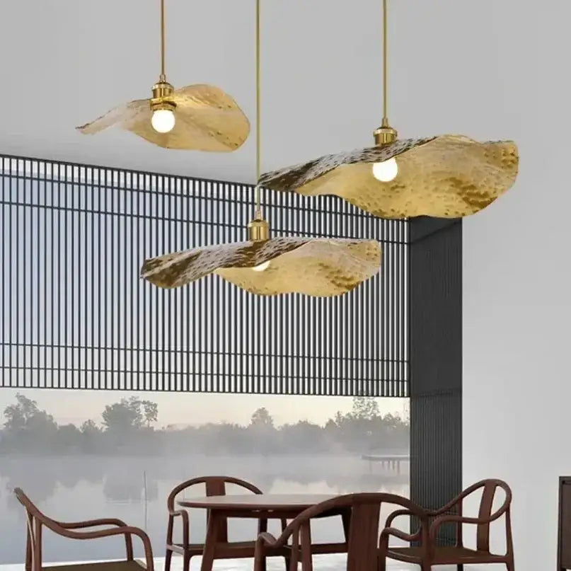 Three golden lotus leaf brass pendant lamps with hammered texture from decorbites for minimalist living room and dining room