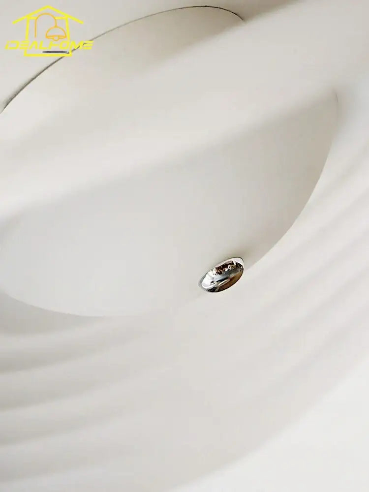 A white decorbites lotus leaf ceiling light with smooth curved resin design and metallic accent for modern home decor