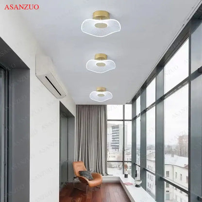 Three decorbites lotus leaf ceiling lights with gold circular bases and translucent petal diffusers emitting soft white glow