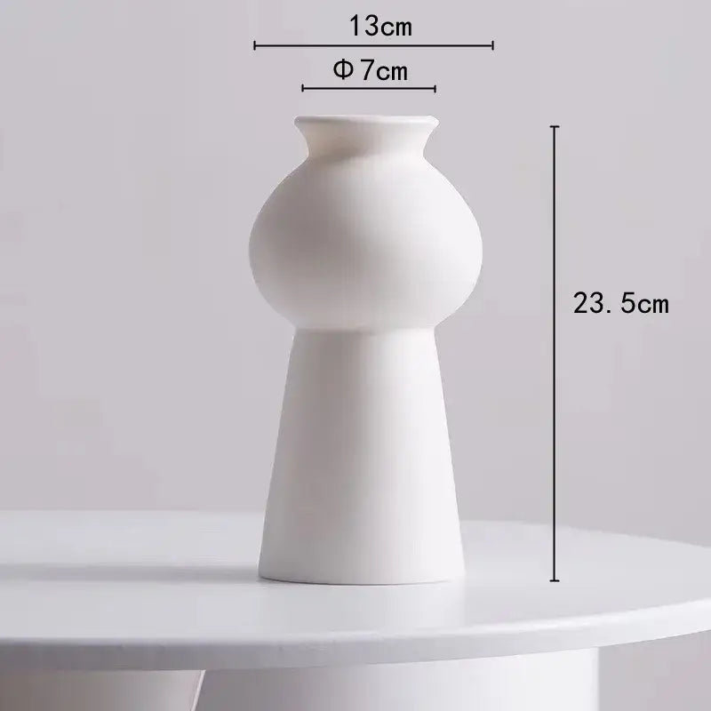 Minimalist white ceramic decorbites lotus leaf vase with rounded body and tapered base for room decoration
