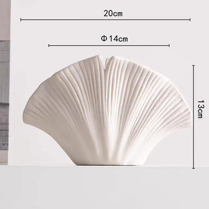A sleek white decorbites lotus leaf ceramic vase shaped like a ginkgo leaf for floral arrangement and decoration