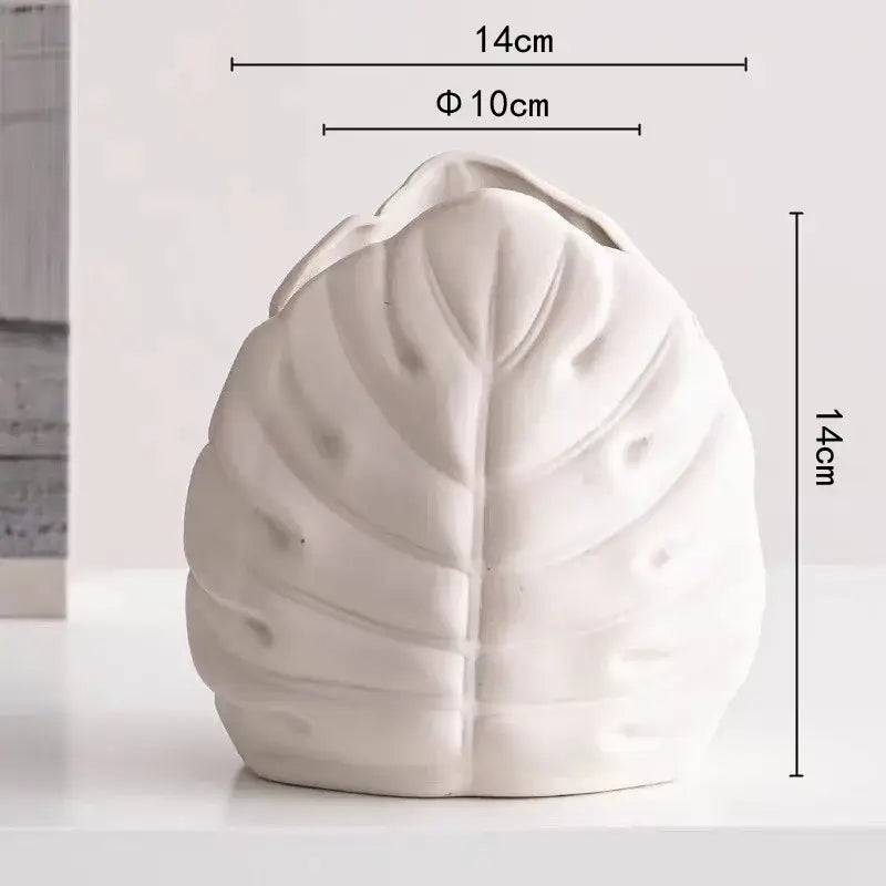 A white ceramic decorbites lotus leaf vase with detailed vein patterns for floral arrangement and room decoration