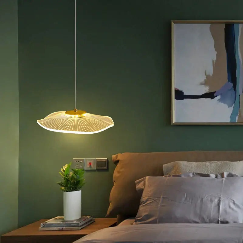 A modern decorbites lotus leaf chandelier with a golden base and illuminated white acrylic fan-shaped shade for indoor decor