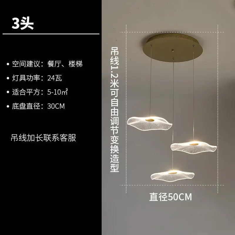 Modern three-head lotus leaf chandelier by decorbites with gold-toned base and translucent acrylic lampshades emitting warm light