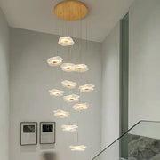 A modern decorbites lotus leaf chandelier with translucent white flower lights and a circular wooden ceiling mount