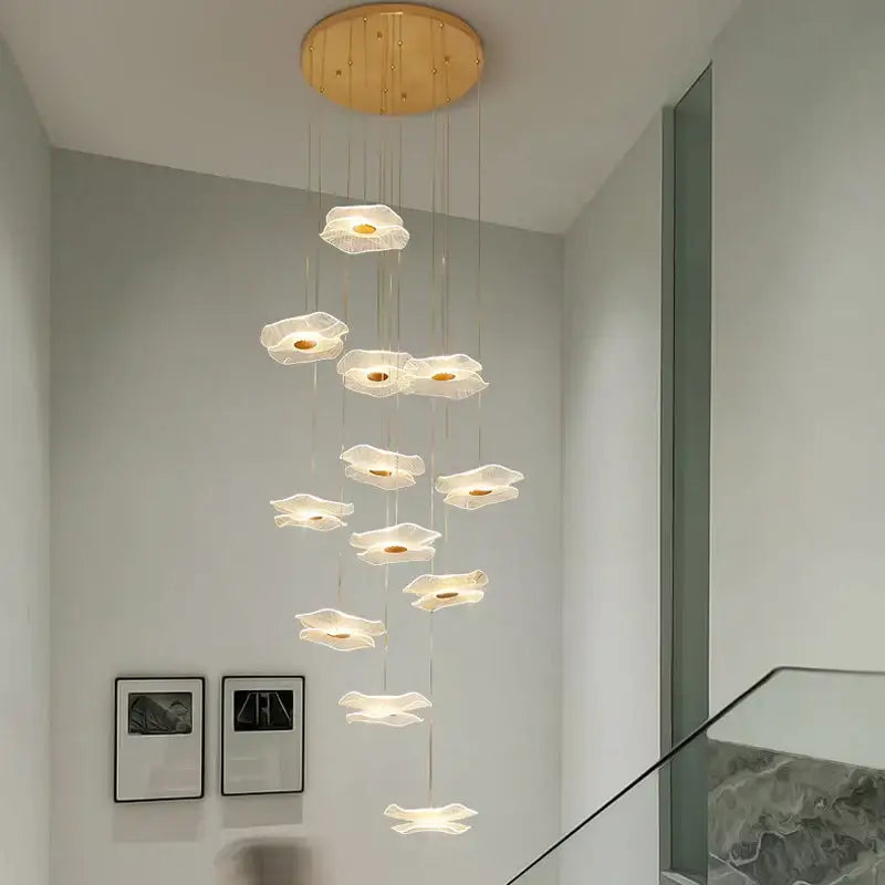 A modern decorbites lotus leaf chandelier with translucent white flower lights and a circular wooden ceiling mount