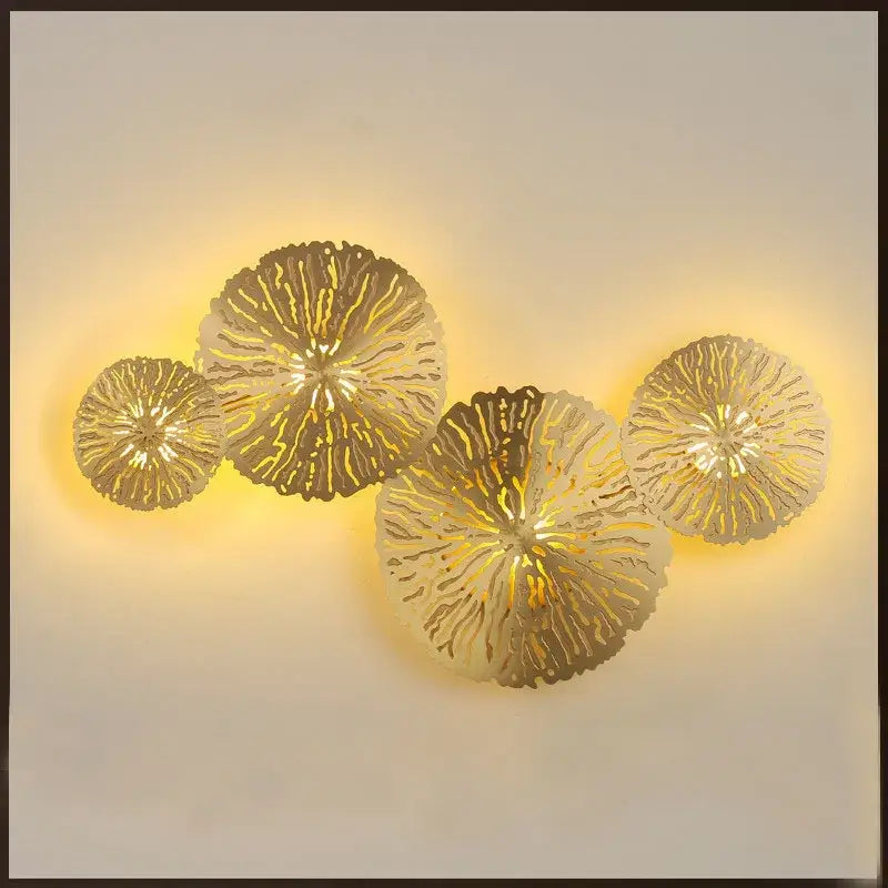 Gold-toned metallic decorbites lotus leaf wall lamp with intricate radiating leaf patterns for home decor lighting
