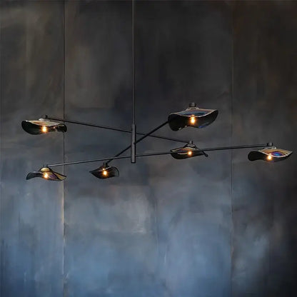 Modern black metal chandelier with five lotus leaf glass shades emitting warm light by DecorBites for living room lighting